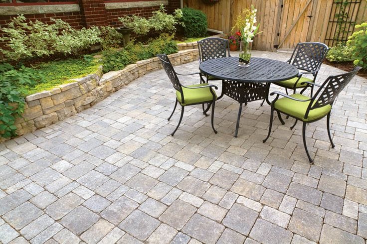 Several chairs arranged on a paved patio, creating a cozy outdoor seating area.
