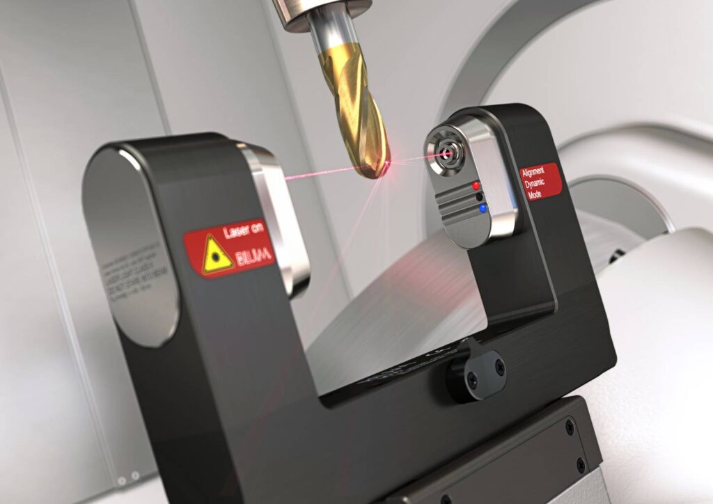 Gold milling tool being measured by red laser beams from a Blum laser tool setter.