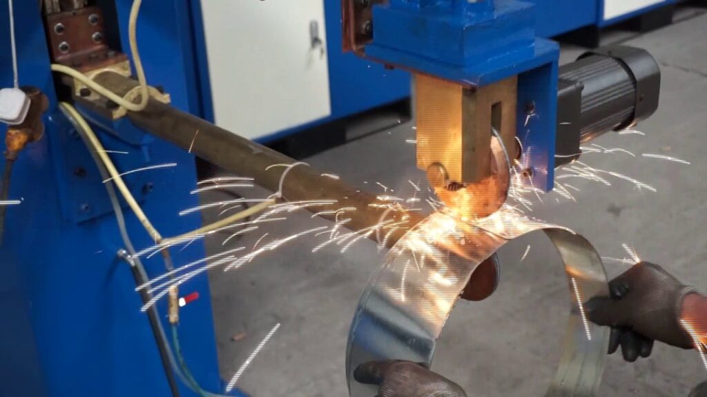 Industrial machine cutting a curved metal piece with sparks flying, held by a gloved hand.