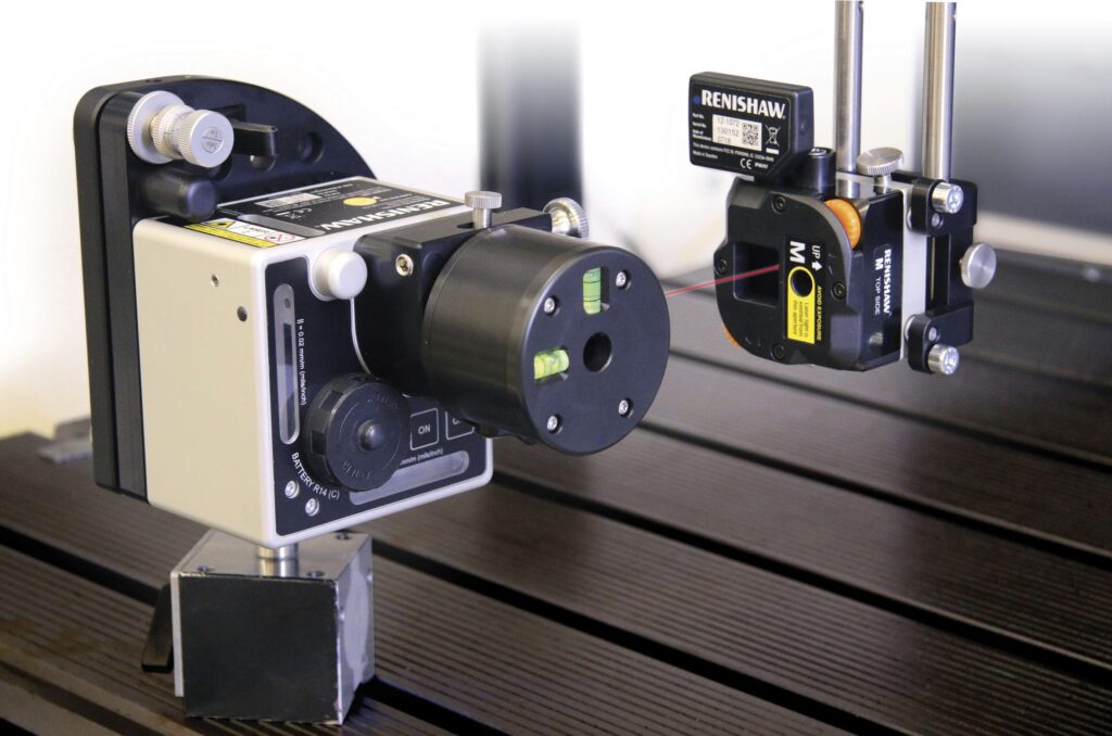 Renishaw laser alignment device directing a thin red laser beam from an emitter into a sensor receiver.