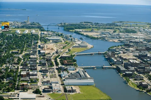 Aerial view of the Port of Green Bay, showing a river flowing through the city into a large body of water.