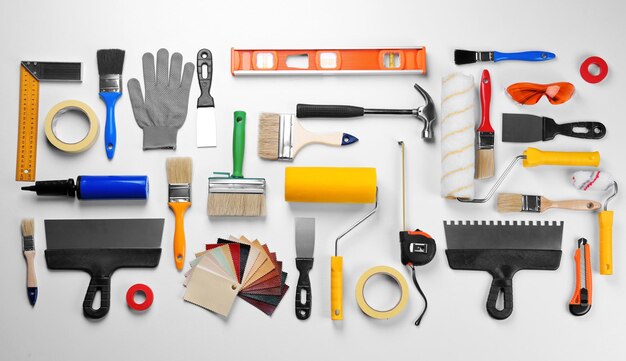 An assortment of home renovation and painting tools neatly arranged on a white background.