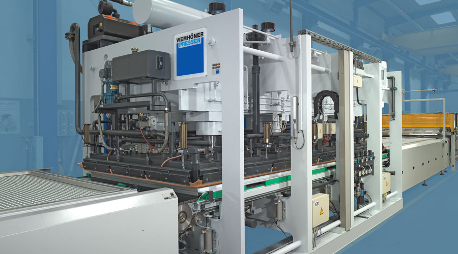 Industrial Wemhöner Pressen machine on a manufacturing line with hydraulic presses.