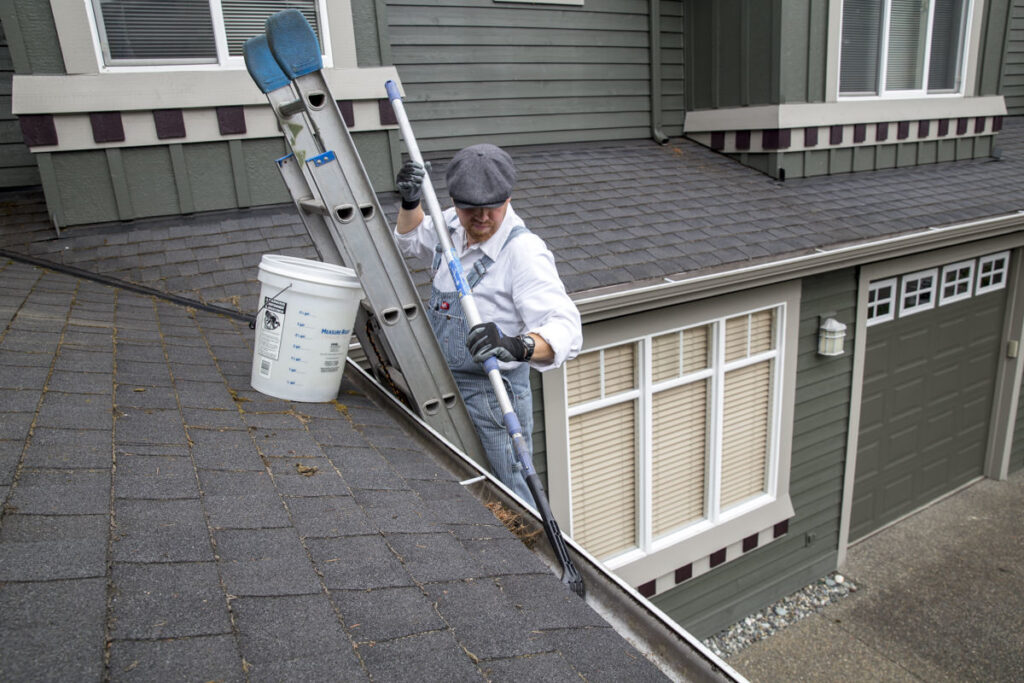 how to clean gutters on 2 story house 1696396476