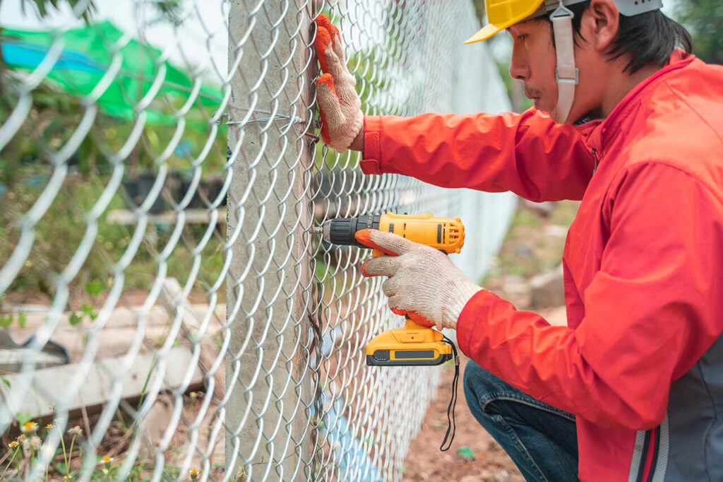 professional repairing chain link fence