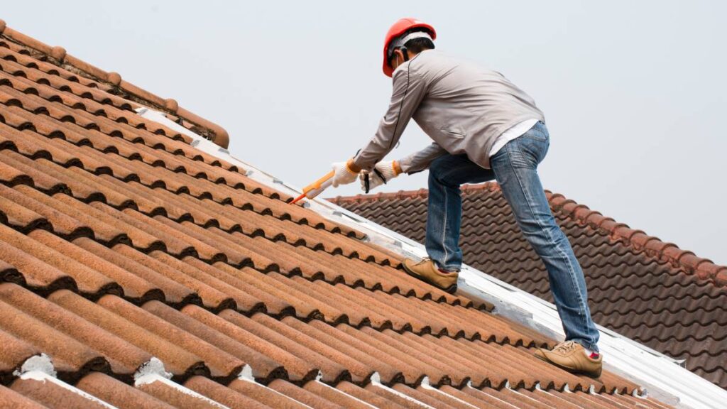 1648519461612 a handyman fixing roof tiles