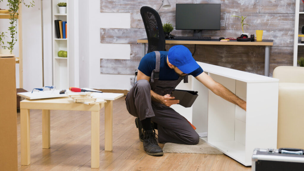 male worker using modern technology furniture assembly new home worker with tablet computer scaled 1