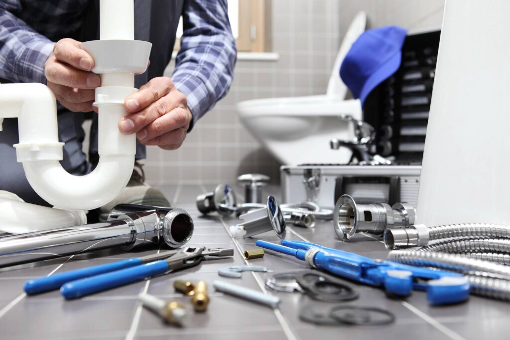 plumber working in bathroom reg4 99466254