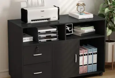 Black mobile office cabinet with a printer on top, open shelves with books, and drawers and binders in cubbies.