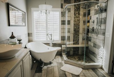 Luxurious bathroom with a white clawfoot tub, glass shower, and white vessel sink.