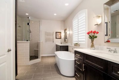 *   Image: A modern, spacious bathroom.
    *   Key elements:
        *   Walk-in shower with glass doors and light-colored t