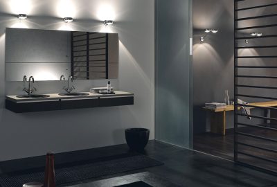 Modern minimalist bathroom with a double floating vanity, large mirror, and soft accent lighting.