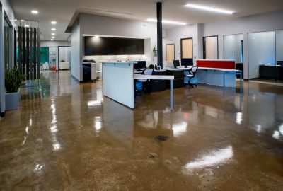 *   Image: A modern office space.
    *   Key elements:
        *   Polished concrete floors (highly reflective).
        *