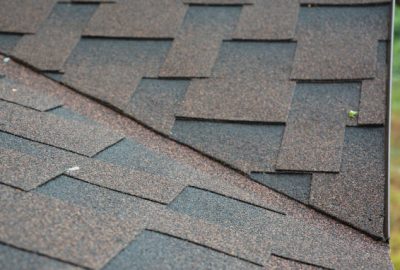 Close-up of overlapping brown asphalt roof shingles