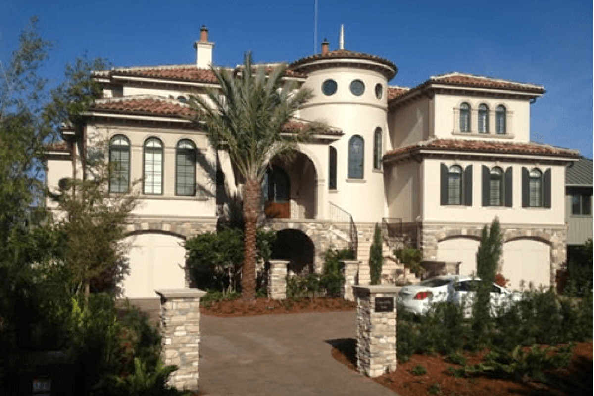 *   Image: A large, luxury Mediterranean-style mansion.
    *   Features:
        *   Cream/beige stucco walls.
        *   R