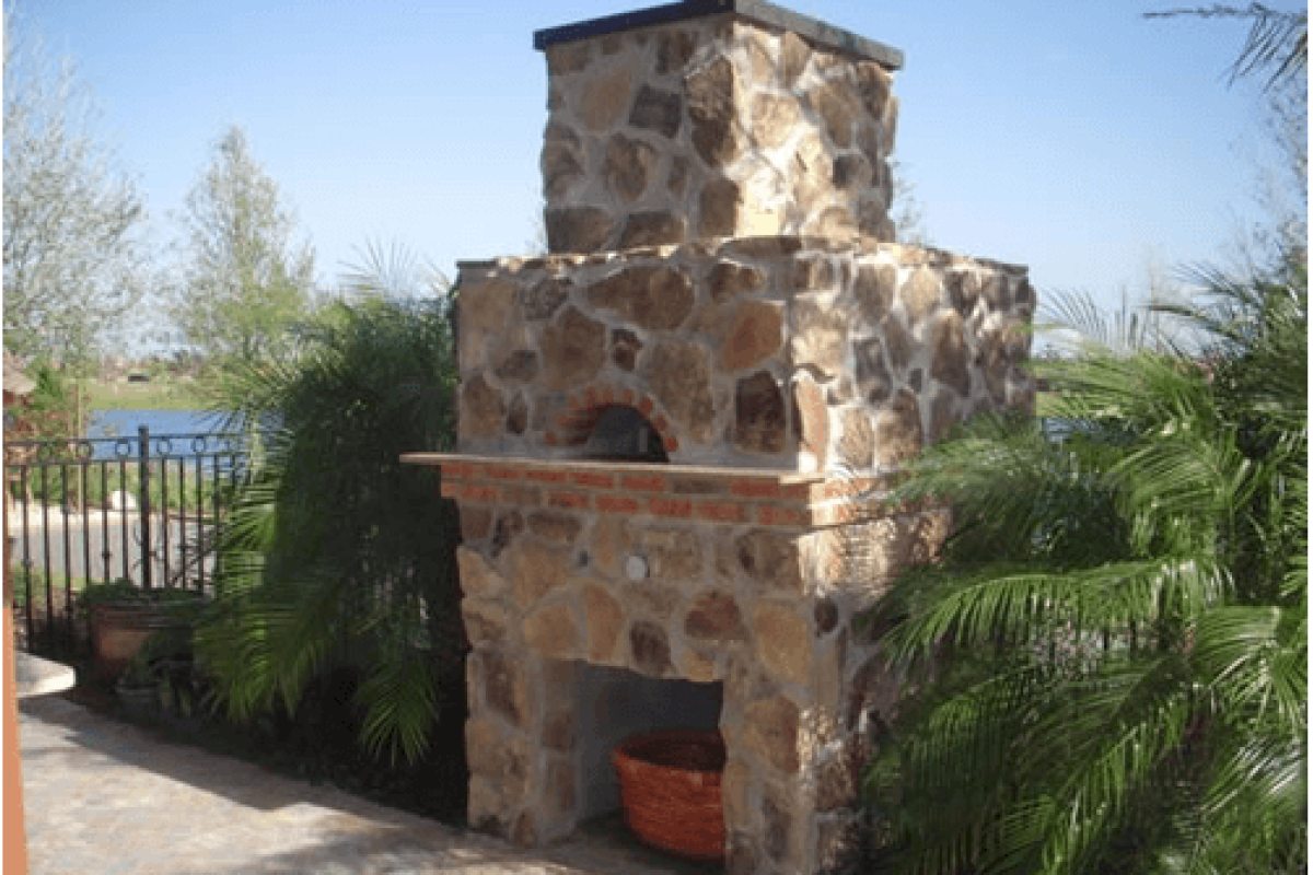 *   Image: A large, outdoor stone fireplace/oven structure.
    *   Material: Rough-cut brown/tan stones with mortar.
    *
