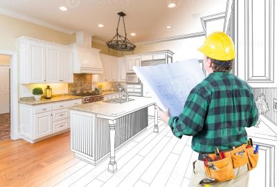 male-contractor-with-hard-hat-and-plans-looking-at-custom-kitchen-drawing-combination-on-white-photo