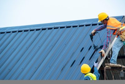 Construction worker wearing safety harness using secondary safet