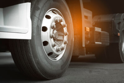 Close-up of a heavy-duty truck tire and metallic wheel rim.