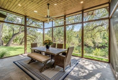 *   Image content: A screened-in porch/patio.
    *   Key elements:
        *   Wooden ceiling with a large white ceiling fan