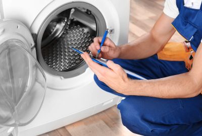 Plumber,With,Clipboard,Near,Washing,Machine
