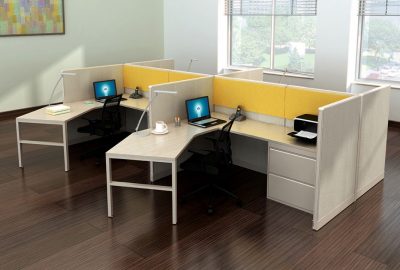 Two modern office cubicles with white L-shaped desks, yellow dividers, laptops, and ergonomic chairs.
