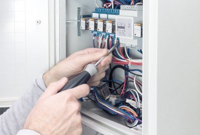 electrician at work on an electrical panel