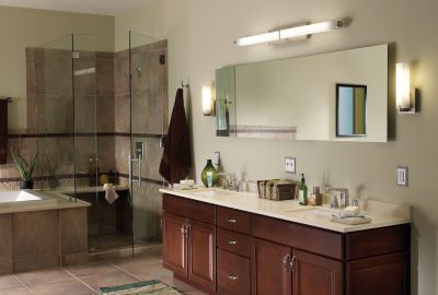 Modern bathroom featuring a double dark wood vanity and a glass-enclosed walk-in shower.