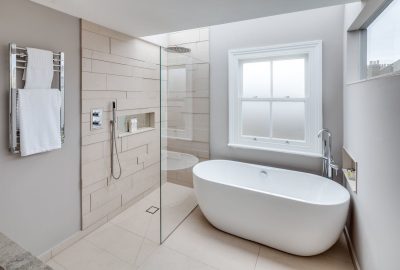 Modern bathroom with a freestanding white bathtub and a walk-in shower with a glass partition.