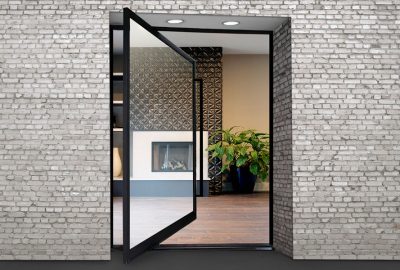 *   Image: An open black-framed glass door set in a white brick wall.
    *   Interior view: A modern room with a fireplace,