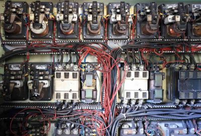 *   Image content: A complex electrical panel with numerous relays, wires (red, black, blue), and components.
    *   Purpose