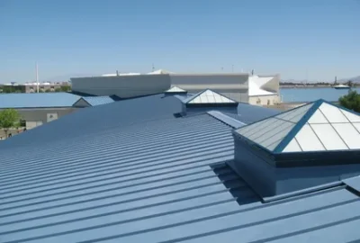 Blue ribbed metal roof with pyramid-shaped skylights.