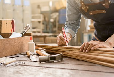 Carpenter,Working,With,Equipment,On,Wooden,Table,In,Carpentry,Shop.