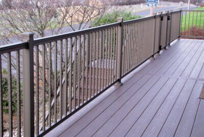 Grey composite decking with a dark metal railing system.