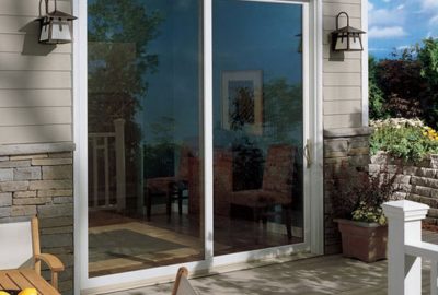 *   Image content: A white-framed sliding glass door leading from a wooden deck into a house.
    *   Details:
        *   Do